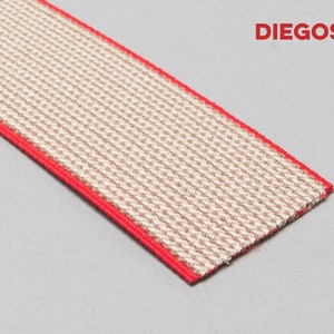 May include: A close-up of a beige elastic band with a red trim. The band is woven with a textured pattern. The text "DIEGOS&reg;" is visible in the upper right corner of the image.