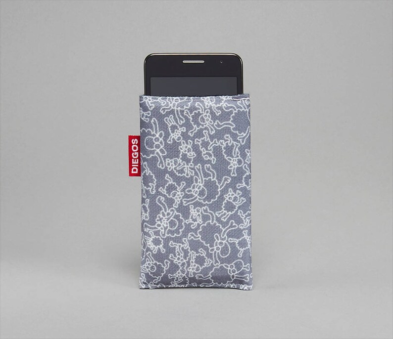 May include: A gray phone case with a white sheep pattern and the word "DIEGOS" printed in red on the side.