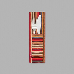 May include: A colorful striped fabric cutlery holder with a silver fork and knife inside. The holder has the word "DIEGOS" printed on the side.