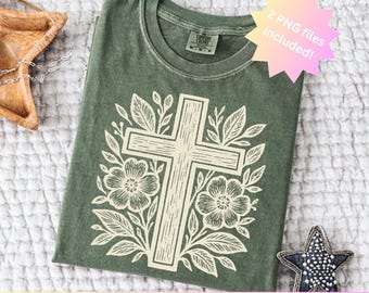 May include: An olive green t-shirt featuring a cream-colored cross design surrounded by floral and leaf elements. The shirt includes the text "2 PNG files included!" and "PNG & SVG included". The shirt is folded and displayed on a textured surface.