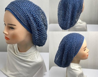 May include: A blue crocheted hat with a solid blue band is displayed on a mannequin head. The hat has a loose, open weave design. The mannequin is wearing a white top.