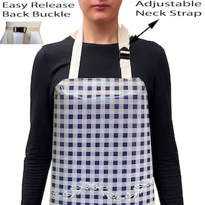 May include: A blue and white checked apron with a rooster design and lace trim. The apron has an adjustable neck strap and an easy release back buckle.