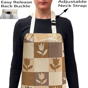 May include: A brown and beige checkered apron with a tulip pattern. The apron has an adjustable neck strap and an easy release back buckle.