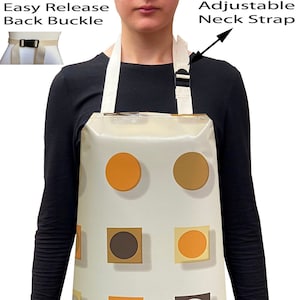 May include: A white apron with an adjustable neck strap and an easy release back buckle. The apron has a geometric pattern of brown, orange, and white circles and squares.