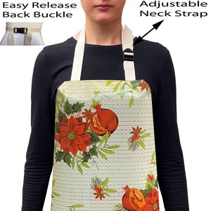 May include: A white apron with a Christmas-themed print featuring red poinsettias, green leaves, and red pomegranates. The apron has adjustable neck straps and an easy-release back buckle.