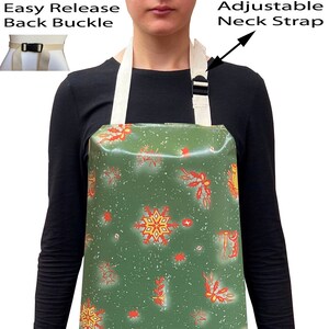May include: A green waterproof apron with a Christmas snowflake pattern. The apron has adjustable neck straps and an easy release back buckle.