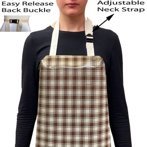 May include: A brown and white checked apron with a rooster and other farm animals printed on the bottom. The apron has adjustable neck straps and an easy release back buckle.