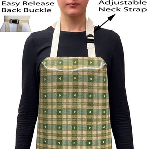 May include: A green and beige checked apron with white hearts. The apron has adjustable neck straps and an easy release back buckle.