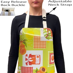 May include: A green, white and orange waterproof apron with a peach and jam print. The apron has an adjustable neck strap and an easy release back buckle.