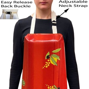 May include: Red waterproof apron with an olive branch and sunflower design. The apron has an adjustable neck strap and an easy release back buckle.