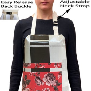 May include: A white apron with a black and white geometric pattern and a red floral print. The apron has adjustable neck straps and an easy release back buckle.