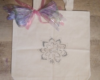 Hand stenciled tote with pink and purple ribbon embellishment