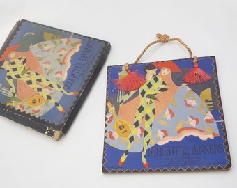 May include: A vintage box and a tile with a colorful illustration of a couple in costume dancing. The text "Delightful Dinners" is printed on both the box and the tile.