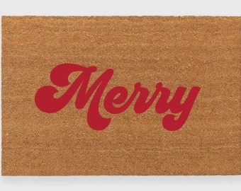 May include: A brown coir doormat with the word "Merry" in red, stylized lettering.