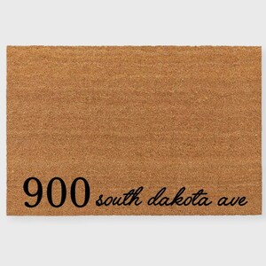 May include: A brown coir doormat with the text "900 south dakota ave" printed in black.