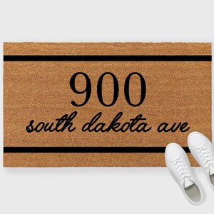 May include: A brown coir doormat with black text that reads "900 south dakota ave" with two black lines above and below the text.
