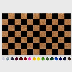 May include: Checkered doormat with black and brown squares. The doormat is made of coir, a natural fiber.