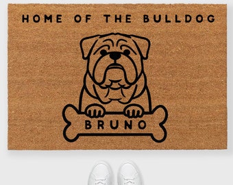 May include: A brown coir doormat with the text "Home of the Bulldog" and a black illustration of a bulldog holding a bone with the name "Bruno" on it.