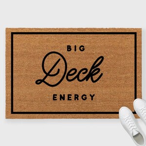 May include: A brown doormat with a black border and the text "BIG Deck ENERGY" in a stylized font.