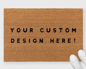 May include: A brown coir doormat with the text "YOUR CUSTOM DESIGN HERE!" printed in black.