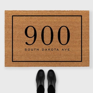 May include: A brown coir doormat with a black frame and the text "900 South Dakota Ave" in white.