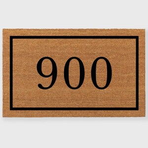 May include: A brown coir doormat with a black border and the number 900 printed in black.