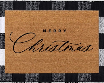 May include: A black and white checkered doormat with the text "Merry Christmas" in a cursive font. Two brown and black winter boots are placed in front of the doormat.