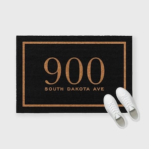 May include: Black doormat with a gold border and the number 900 in gold lettering. The text "South Dakota Ave" is also in gold lettering.