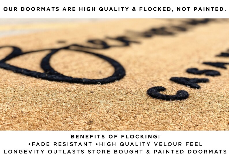 May include: A natural coir doormat with black flocked lettering. The text at the top reads "OUR DOORMATS ARE HIGH QUALITY & FLOCKED, NOT PAINTED." The bottom text lists the benefits of flocking: fade resistant, high quality velour feel, and longevity.