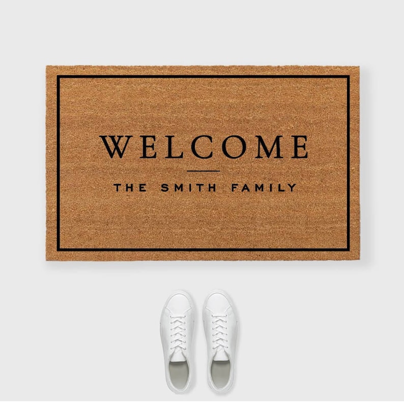 May include: A brown doormat with a black border and the text 'WELCOME THE SMITH FAMILY' in black font.