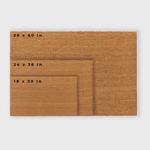 May include: Three brown coir doormats of different sizes. The largest mat measures 36 x 60 in., the middle mat measures 24 x 36 in., and the smallest mat measures 18 x 30 in.