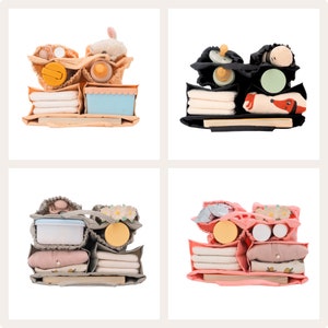 May include: Four different diaper bags with various compartments and pockets, each filled with different baby items, including diapers, wipes, bottles, toys, and clothing. The bags are in different colors, including beige, black, gray, and pink.