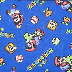 May include: A blue fabric featuring a repeating pixelated pattern of Super Mario World characters including Mario riding Yoshi, red and white mushrooms, yellow question mark blocks, and orange flowers, with the text Super Mario World printed.