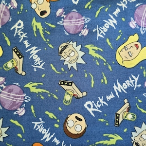 May include: A blue fabric featuring a repeating pattern of Rick and Morty characters, purple planets with rings, portal guns, and green portal energy streaks. The text Rick and Morty is printed in white throughout the fabric design.