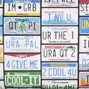 May include: A fabric pattern featuring a collage of various United States license plates with text including IM GR8, I NV U, UR THE 1, URA QT 2, 4 GIVE ME, 2 COOL 4U, and COOL-IT. The design displays colorful state names, slogans, and graphics.