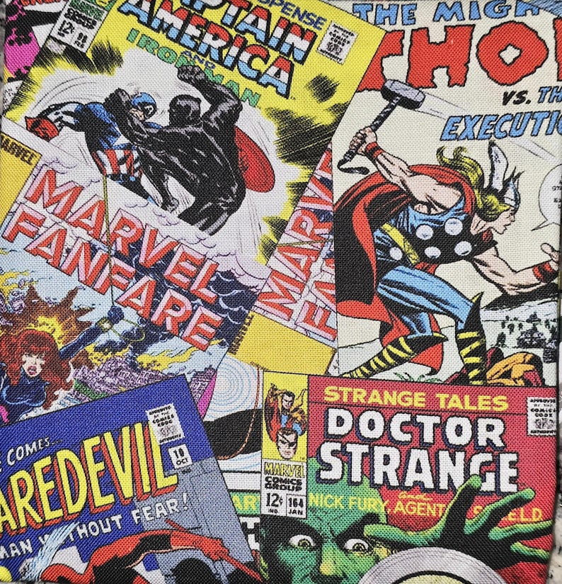 May include: A fabric print featuring a collage of vintage Marvel comic book covers including Captain America, Iron Man, Thor, Daredevil, and Doctor Strange. The colorful graphic design displays various superhero illustrations and bold comic book titles.