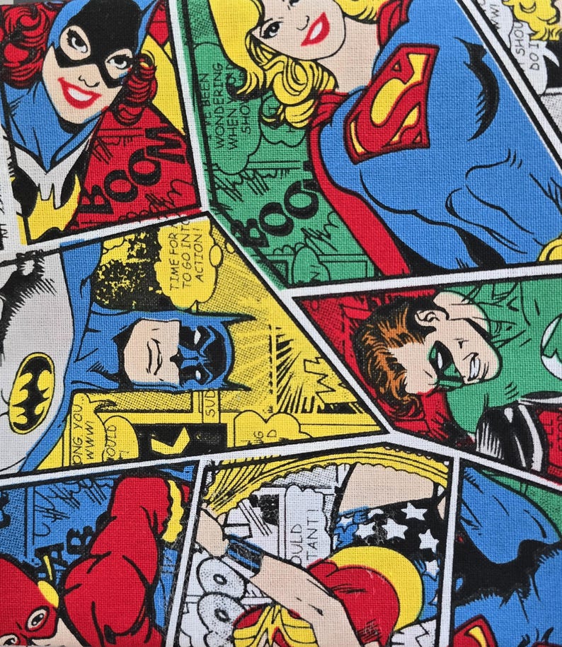 May include: A fabric print featuring a collage of DC comic book panels with characters including Batgirl, Supergirl, Batman, Green Lantern, The Flash, and Wonder Woman. The design uses vibrant primary colors and includes speech bubbles with text.