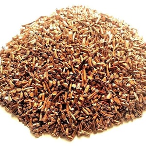 May include: A pile of copper shavings, a metallic material used in various applications.