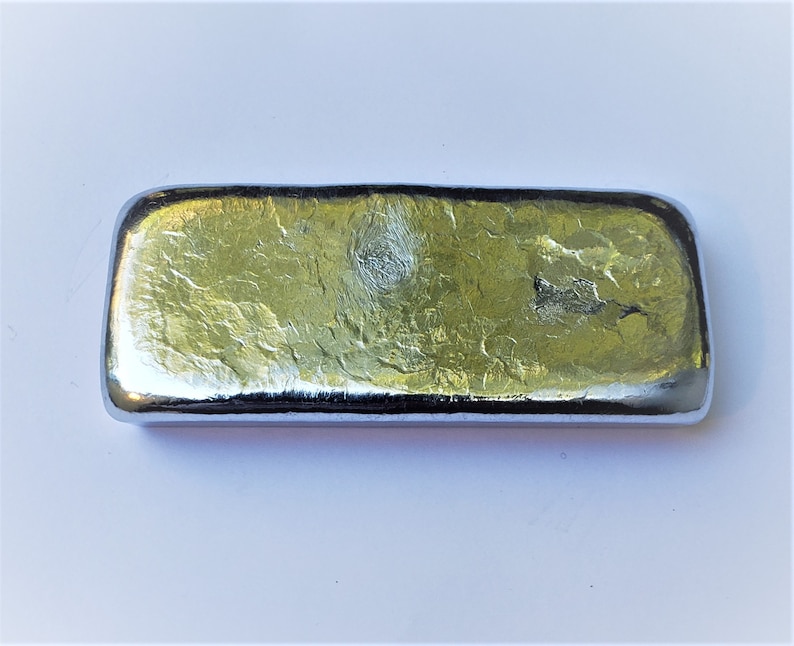 May include: A silver-colored metal bar with a textured surface.