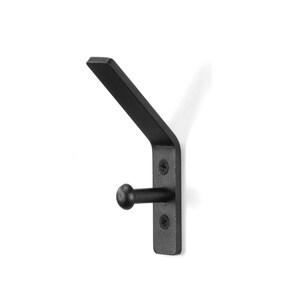 May include: Black metal wall hook with a rounded end. The hook is mounted on a rectangular plate with two visible screws.