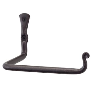 May include: A black metal toilet paper holder with a curved arm and a decorative scroll design at the end. The holder is mounted to a wall.