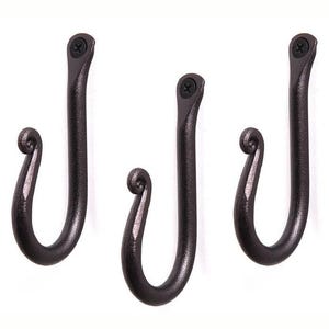 May include: Three dark bronze-colored, hand-forged metal hooks. Each hook has a curved, scroll-like design at the bottom and a flat top with a screw. The hooks are designed for hanging items and add a rustic touch to any space.