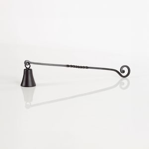 May include: A black metal candle snuffer with a bell-shaped end and a twisted handle. The handle ends in a decorative curl.