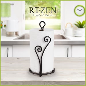 May include: Black metal paper towel holder with a decorative scroll design. The holder is holding a white paper towel roll. RT-ZEN Iron-Craft D&eacute;cor.