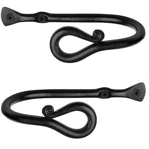 May include: A pair of black metal curtain tiebacks with a decorative swirl design.