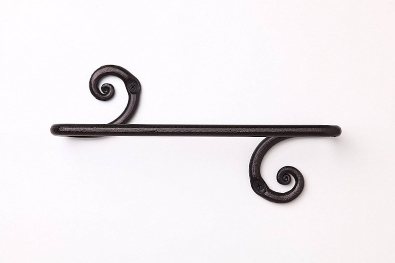 May include: Black metal towel rack with decorative scrollwork on the ends.