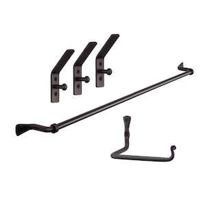 May include: Black metal towel bar with three matching hooks and a matching towel ring. The towel bar and hooks are mounted on a white wall.