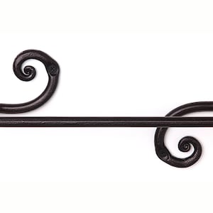 May include: Black metal towel rack with decorative scrollwork on the ends.