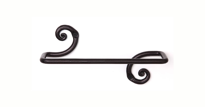 May include: Black metal towel rack with decorative scrollwork on the ends.