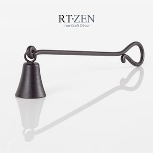 May include: A black metal candle snuffer with a bell-shaped head and a long, curved handle. RT.ZEN Iron-Craft Décor is printed on the handle.